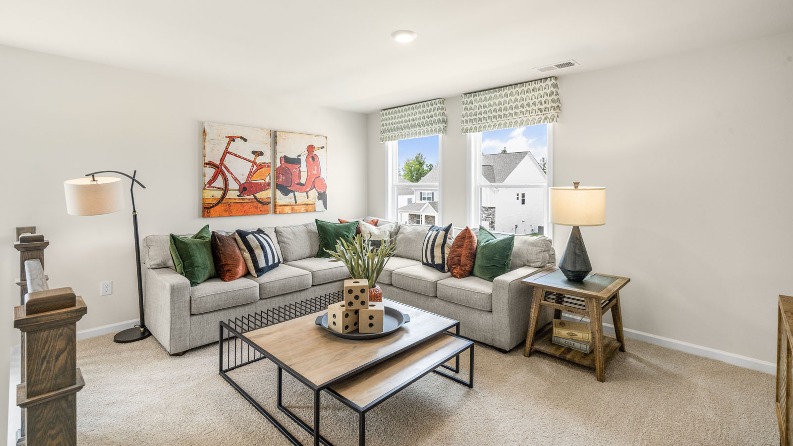 upstairs loft area with large windows and carpeting