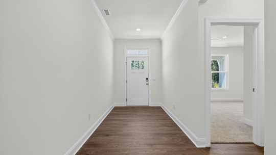 foyer entryway facing front door with bedroom on the right