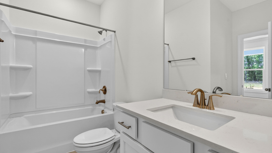 bathroom with tub shower combo and quartz countertops