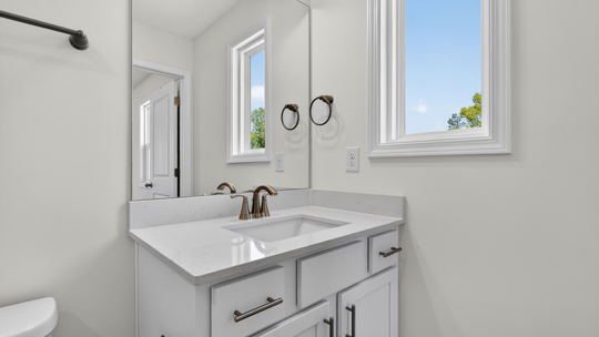 bathroom with vanity and quartz countertops