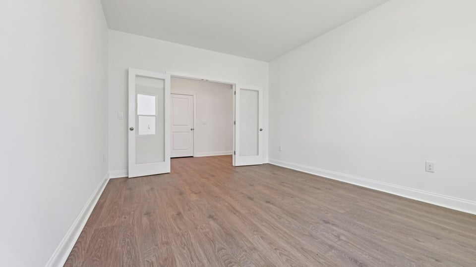 study with french glass doors and revwood flooring