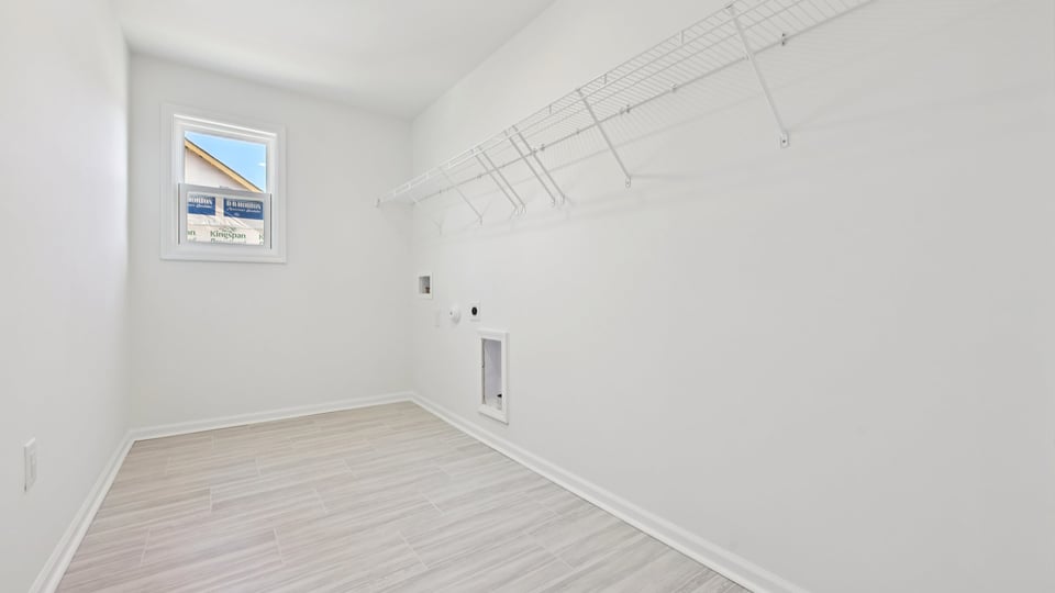 laundry room with window and tile flooring