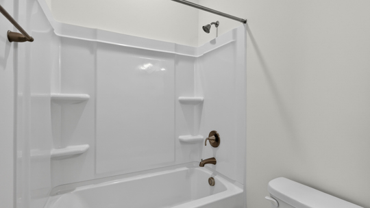 secondary bathroom with shower tub combo and single vanity sink