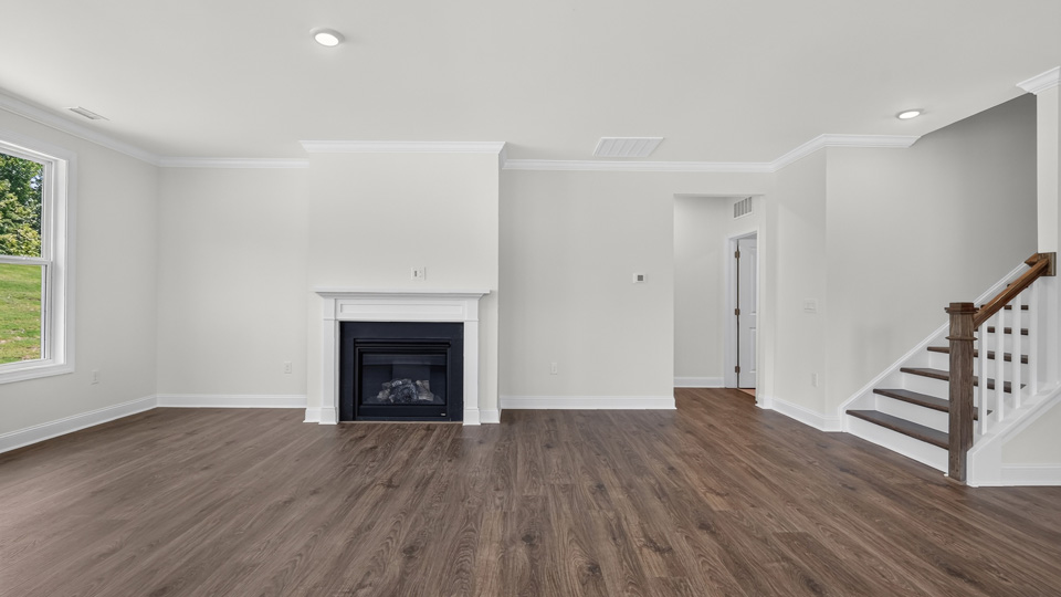 open concept living space with large windows, fireplace