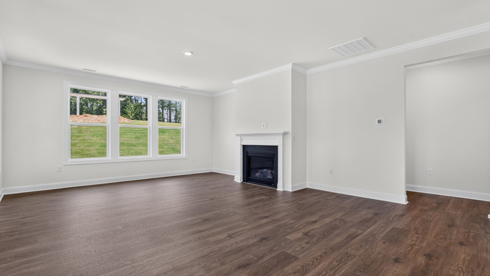 open concept living space with large windows, fireplace