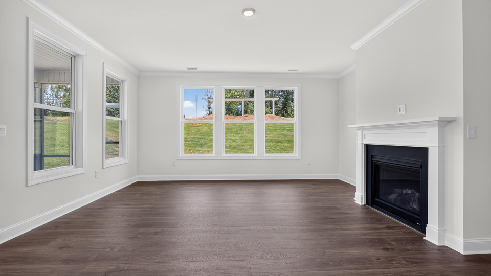 open concept living space with large windows, fireplace