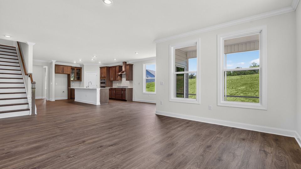 kitchen with quartz counters, kitchen island, pantry, stainless steel appliances