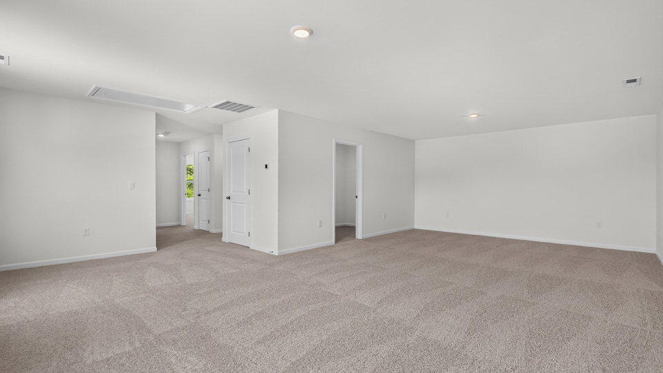 upstairs loft area with large windows and carpeting
