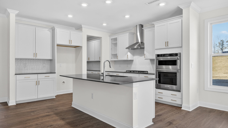 kitchen with spacious island white cabinets and quartz countertops
