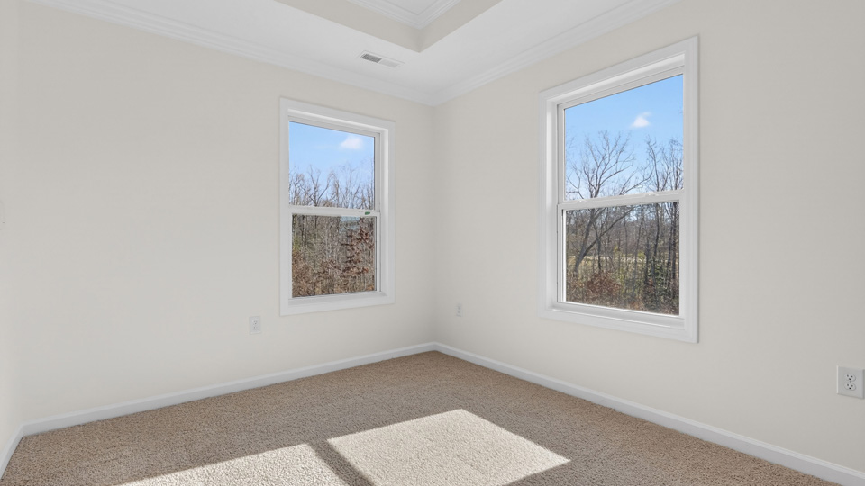 sitting room with carpet flooring in primary bedroom