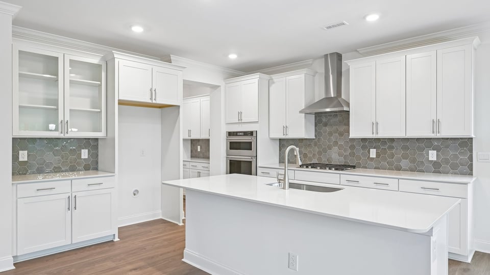 gourmet kitchen with island white cabinets and quartz countertops