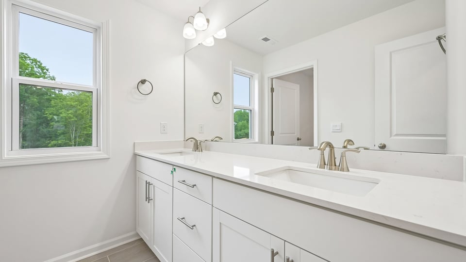 bathroom with quartz countertops and dual vanity