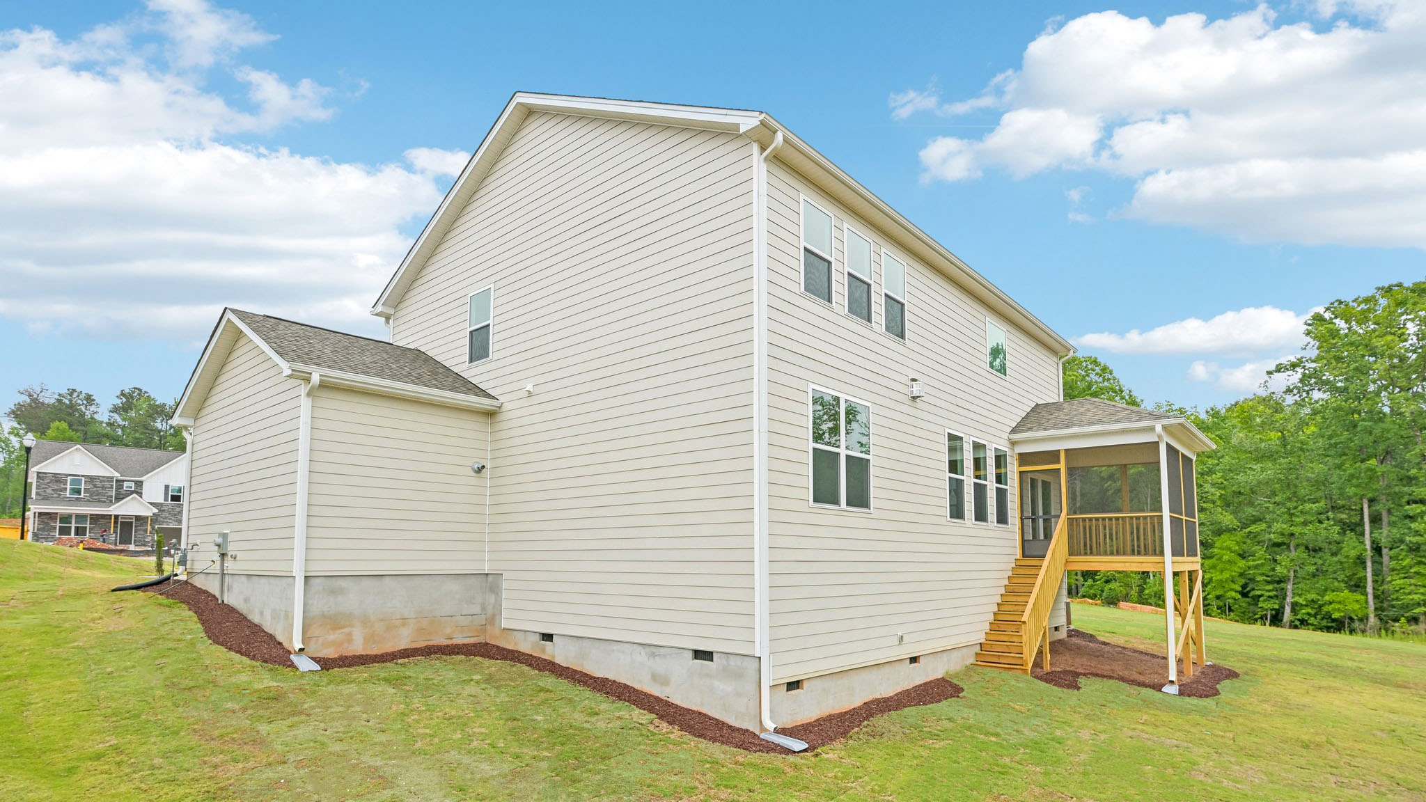 back of home on crawl space with covered and screened back deck