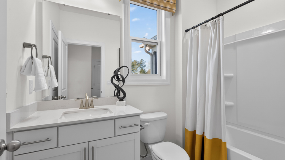 secondary bathroom with shower tub combo and single vanity sink