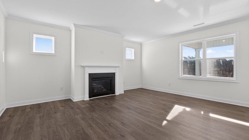 Open-concept living room with hardwood floors and windows