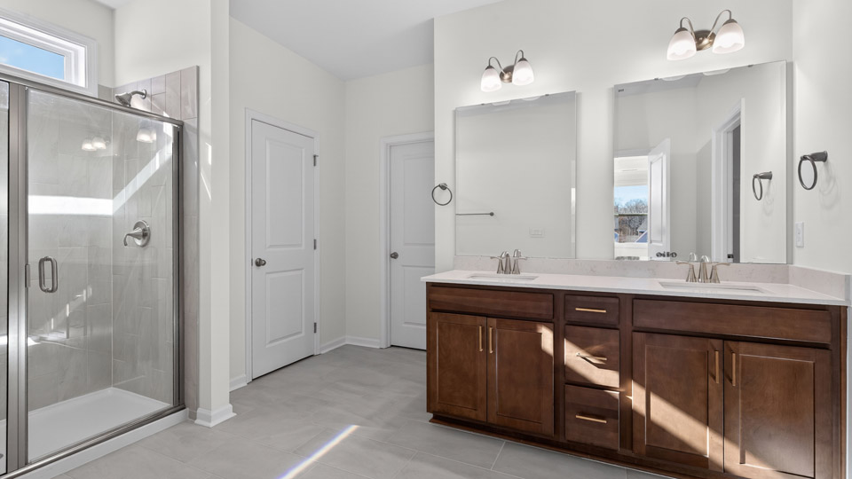 Primary bathroom with double sink and walk in shower