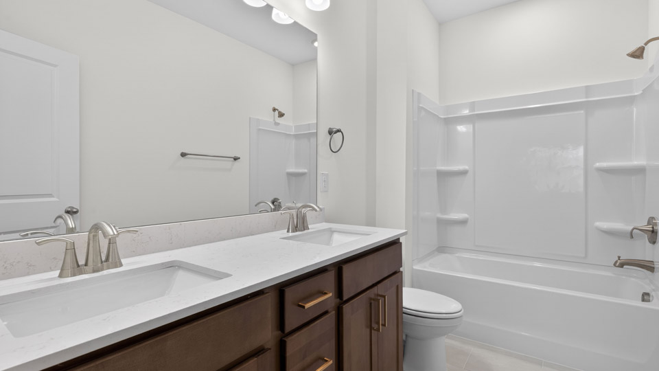 Bathroom with double sink and tub