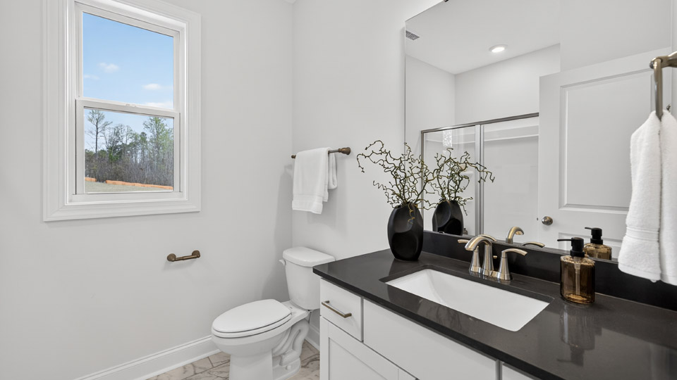 bathroom with quartz countertops and white cabinets