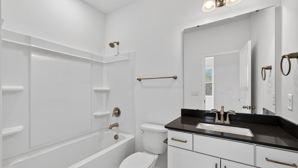 secondary bathroom with shower tub combo and single vanity sink
