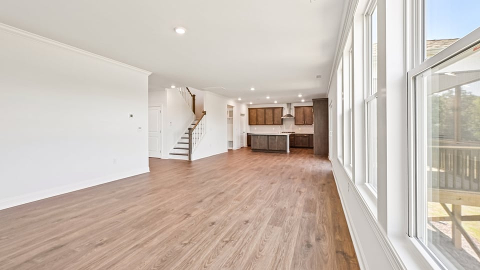 open concept living space with large windows, fireplace