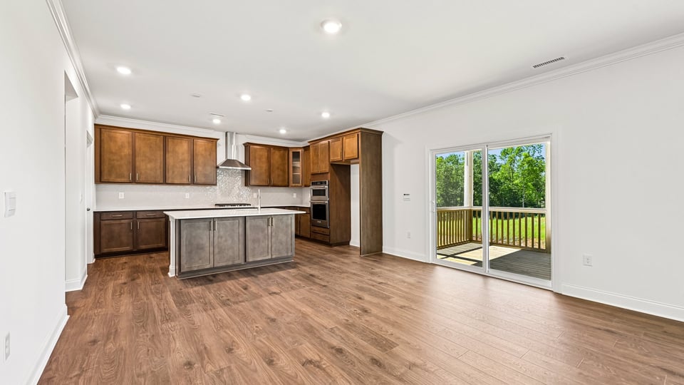kitchen with quartz counters, kitchen island, pantry, stainless steel appliances