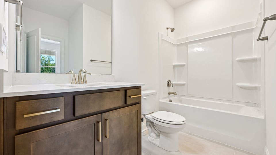 secondary bathroom with shower tub combo and single vanity sink