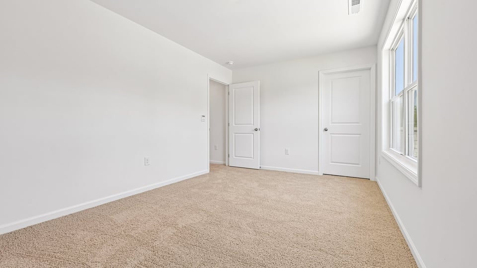 additional bedroom with window, carpeting, closet