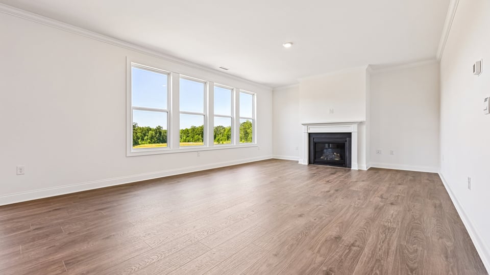 open concept living space with large windows, fireplace