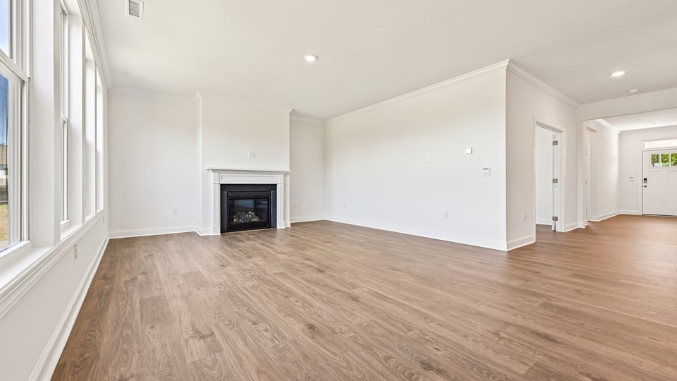 open concept living space with large windows, fireplace