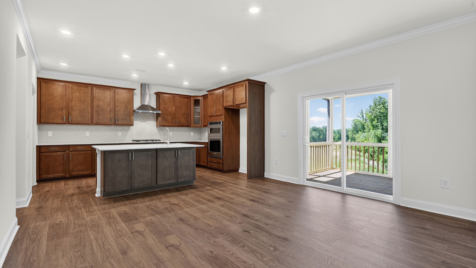 kitchen with quartz counters, kitchen island, pantry, stainless steel appliances