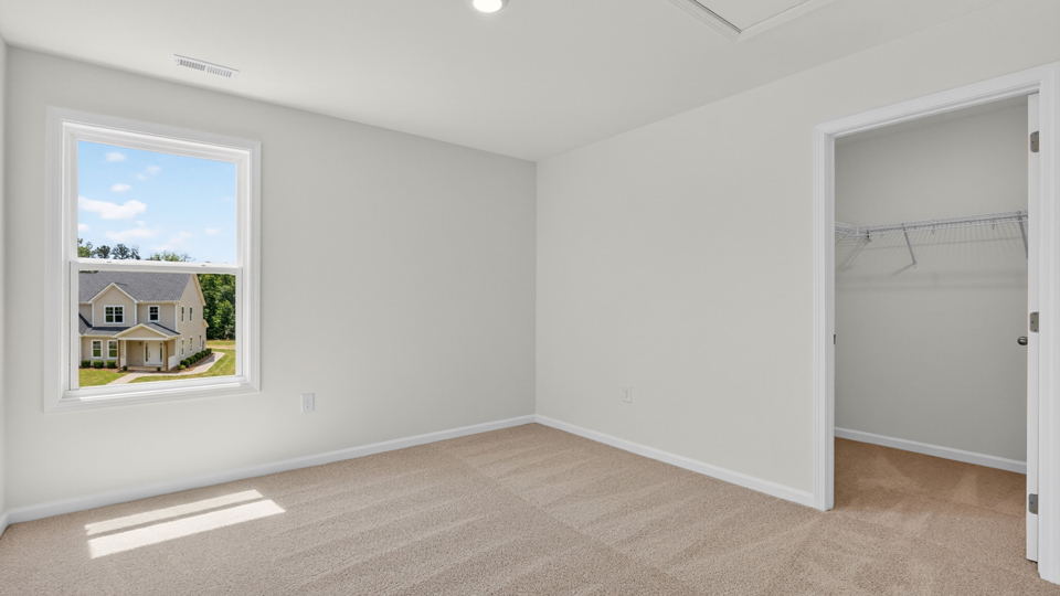 additional bedroom with window, carpeting, closet
