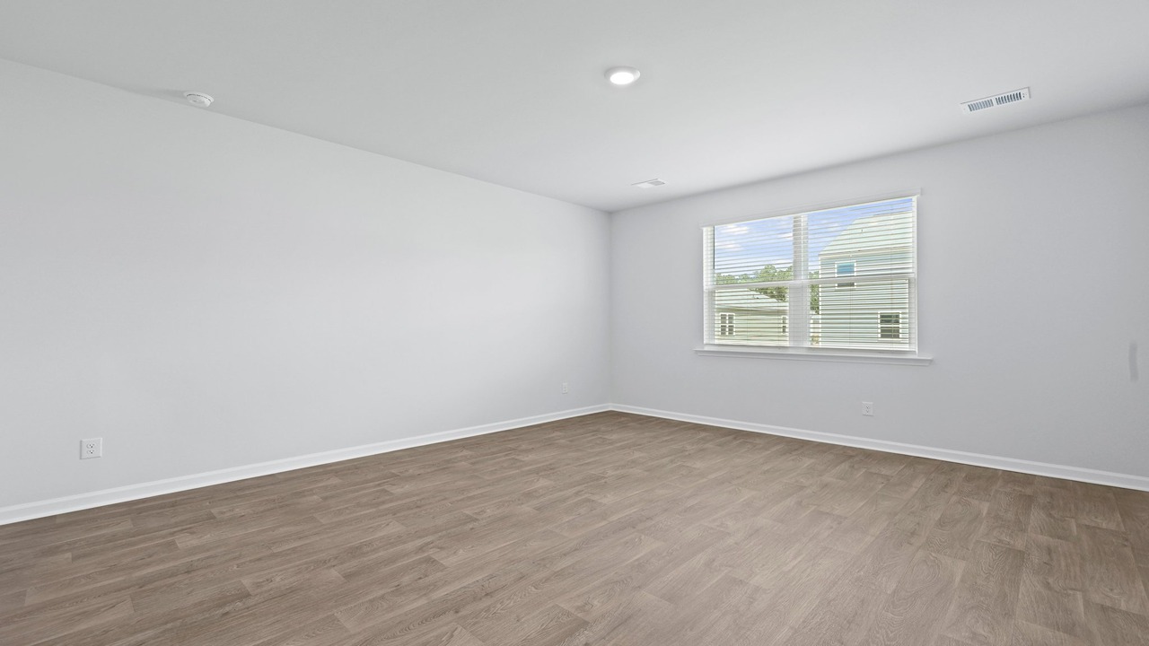 Primary bedroom with large windows