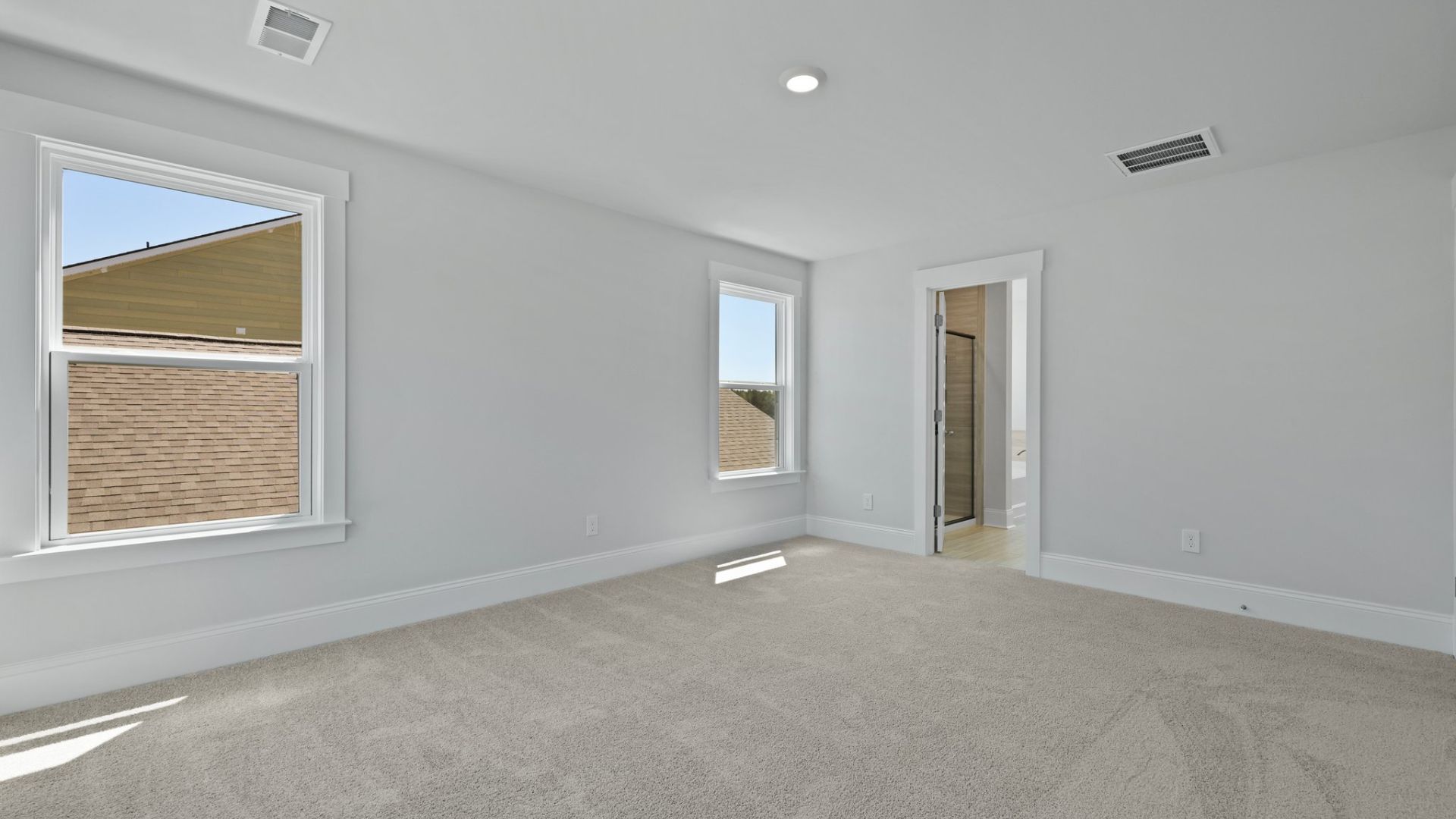 Primary bedroom with large windows