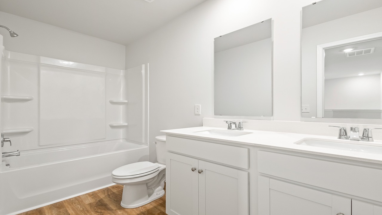 guest bathroom with dual vanity