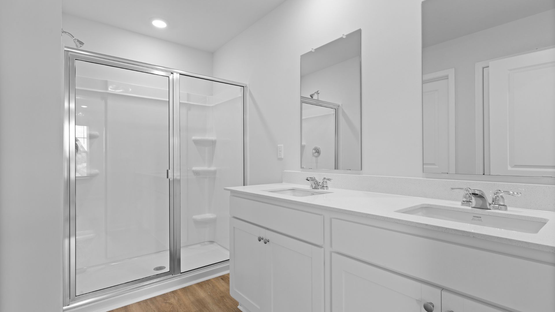 Dual vanities and a standup walk-in shower in the primary bathroom.