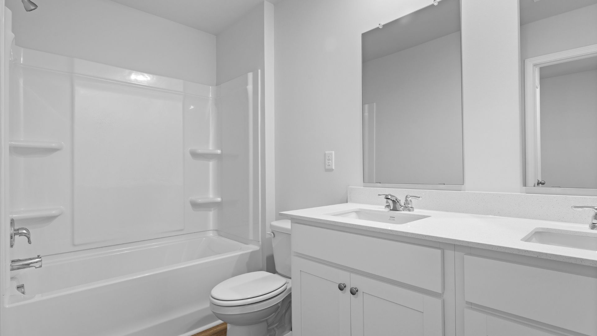 Dual vanities and a tub-shower combo in the secondary bathroom.