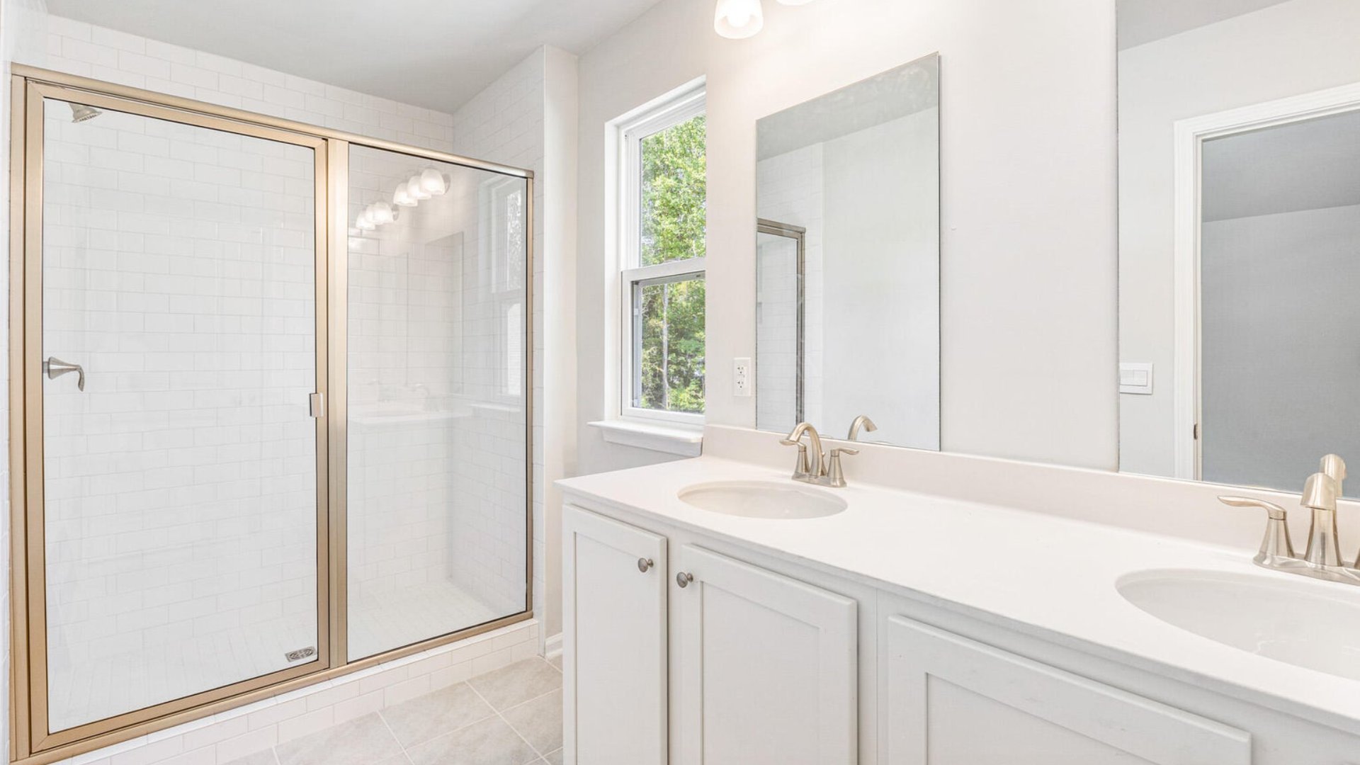 There are double vanitites and a standup walk-in shower in the private primary bathroom.