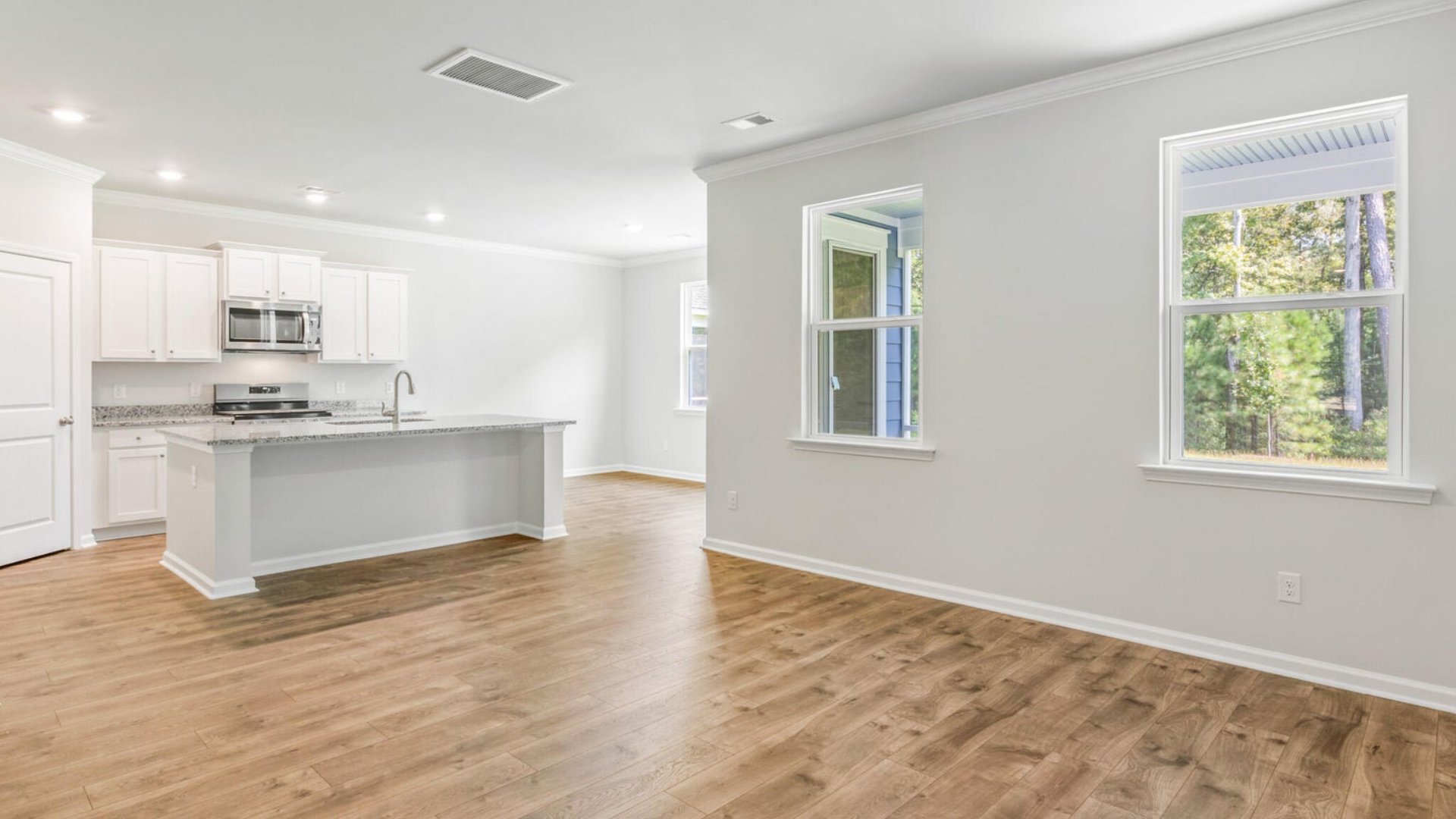 The open-concept living, dining and kitchen are spacious and bright.