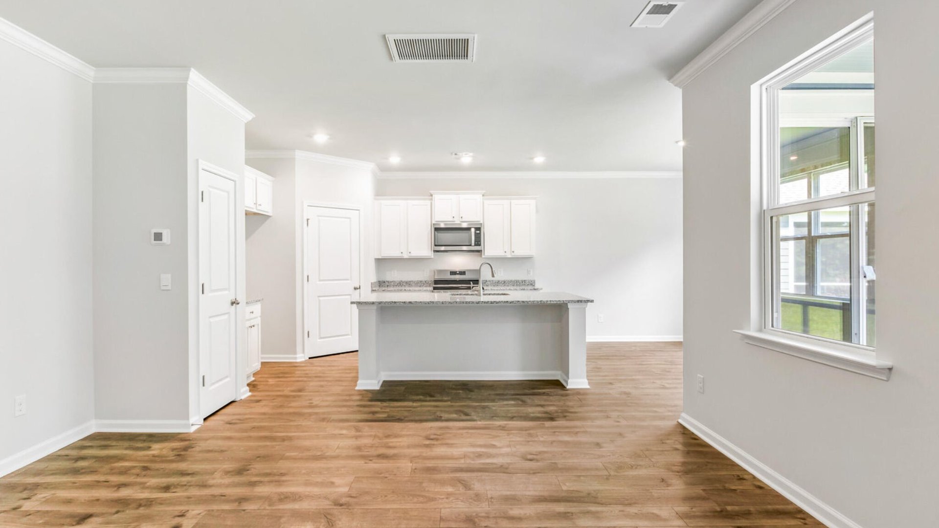 The kitchen has ample storage with cabinets and a spacious pantry.