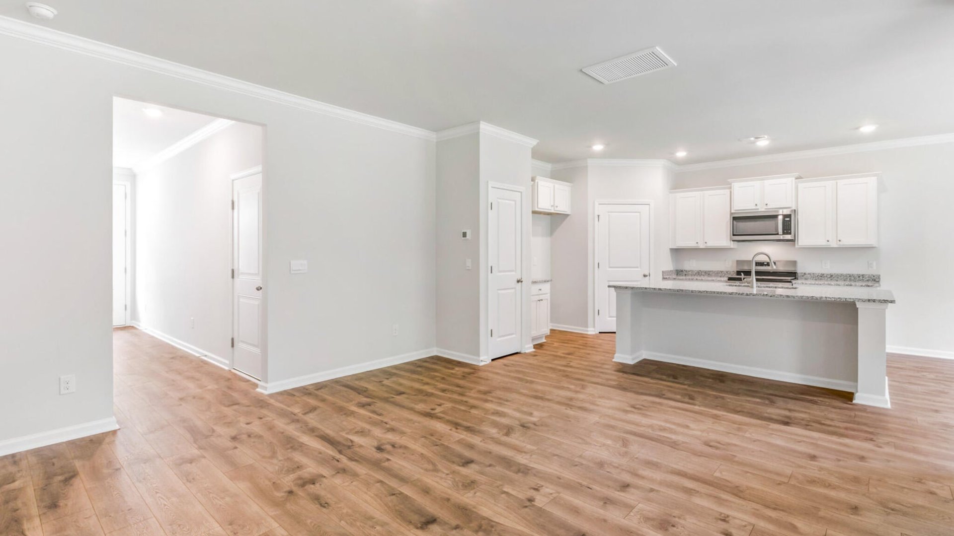 The entry way leads to the bright and spacious open-concept kitchen, living room and dining room.