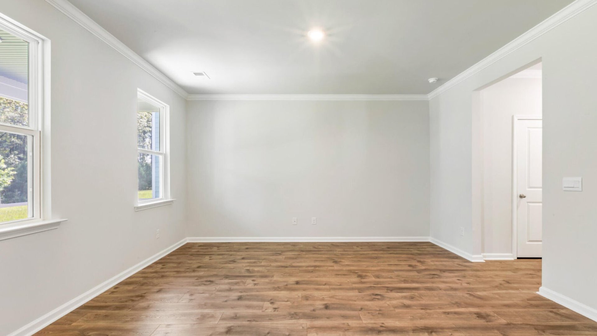 The living room is well-lit from windows and is perfect for hosting and entertaining guest.