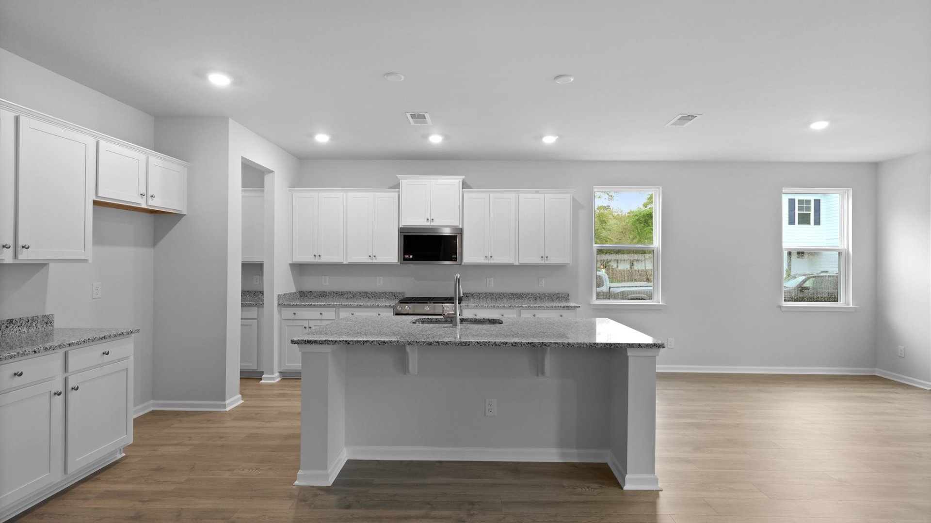 The floating island in the kitchen can fit barstools offering extra seating.