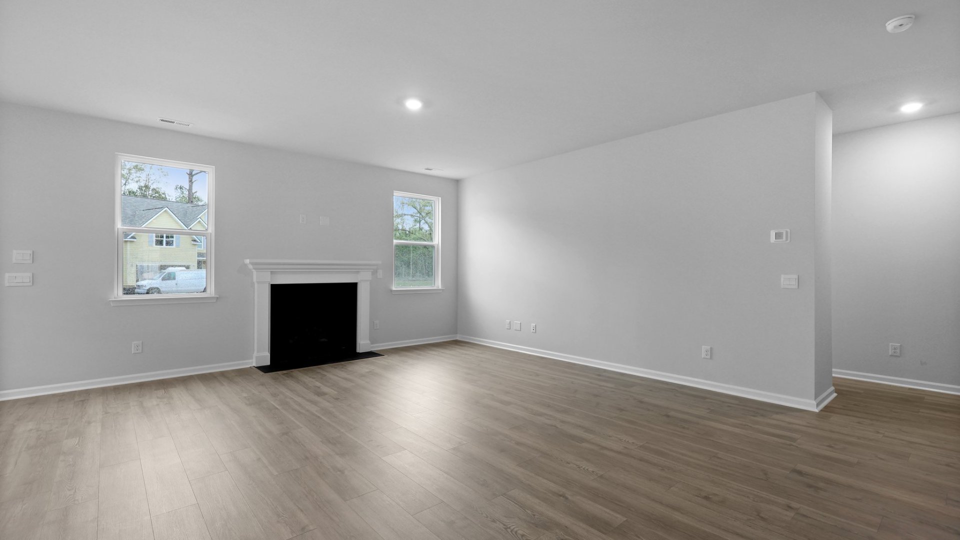 The living room features a fireplace and windows providing the space with natural lighting.