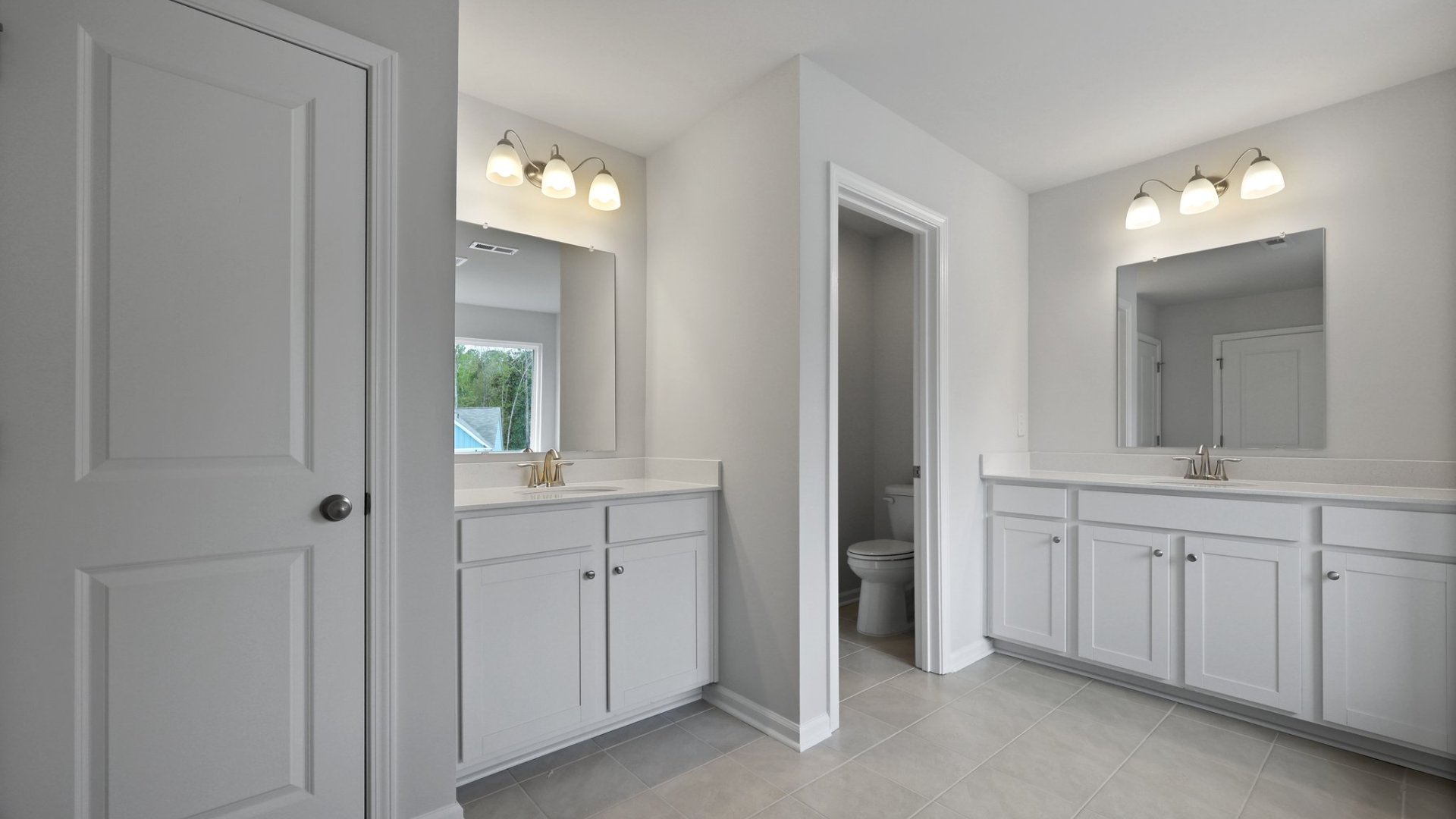 Seperate double vanities are located in the primary bathroom.