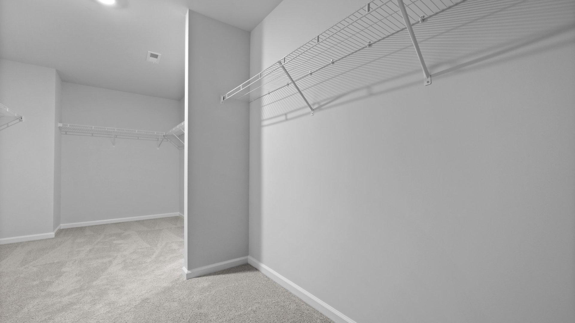 The spacious walk-in closet located in the primary bathroom.