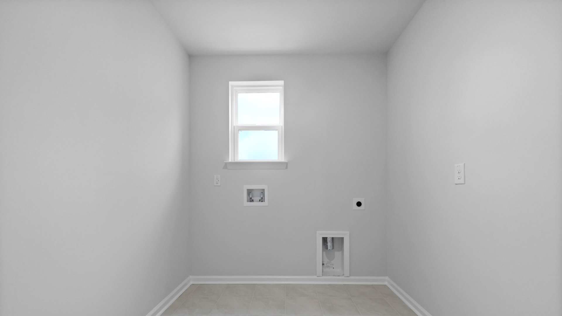 The laundry room has natural lighting from the window located inside.