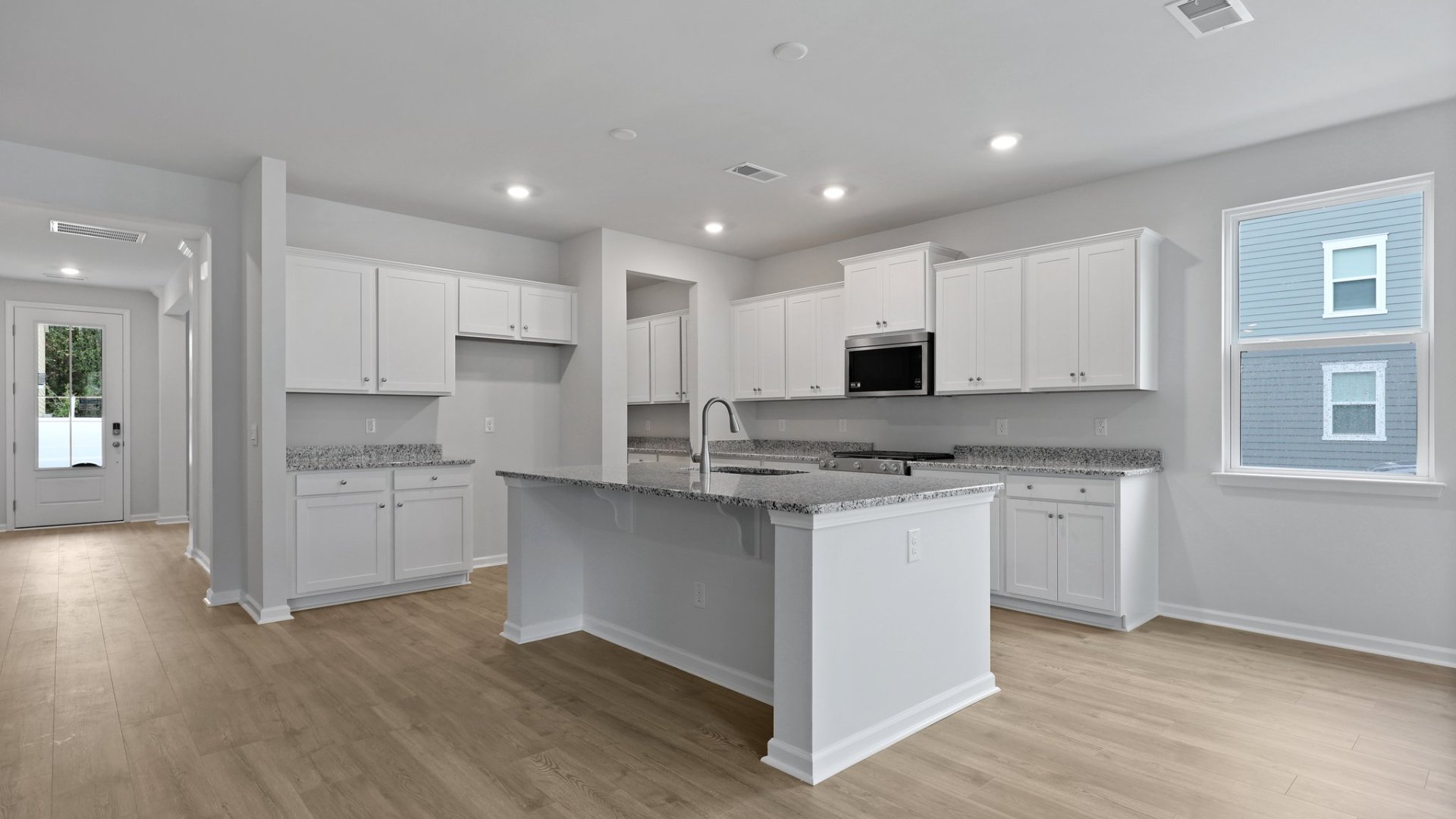 The kitchen, living room, and dining room are open concept in the Harbor Oak floorplan.