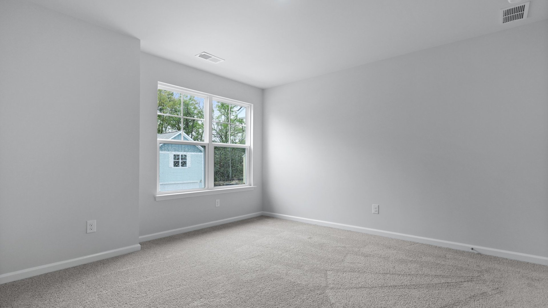 Bedroom 2 is located upstairs with large windows for natural lighting,