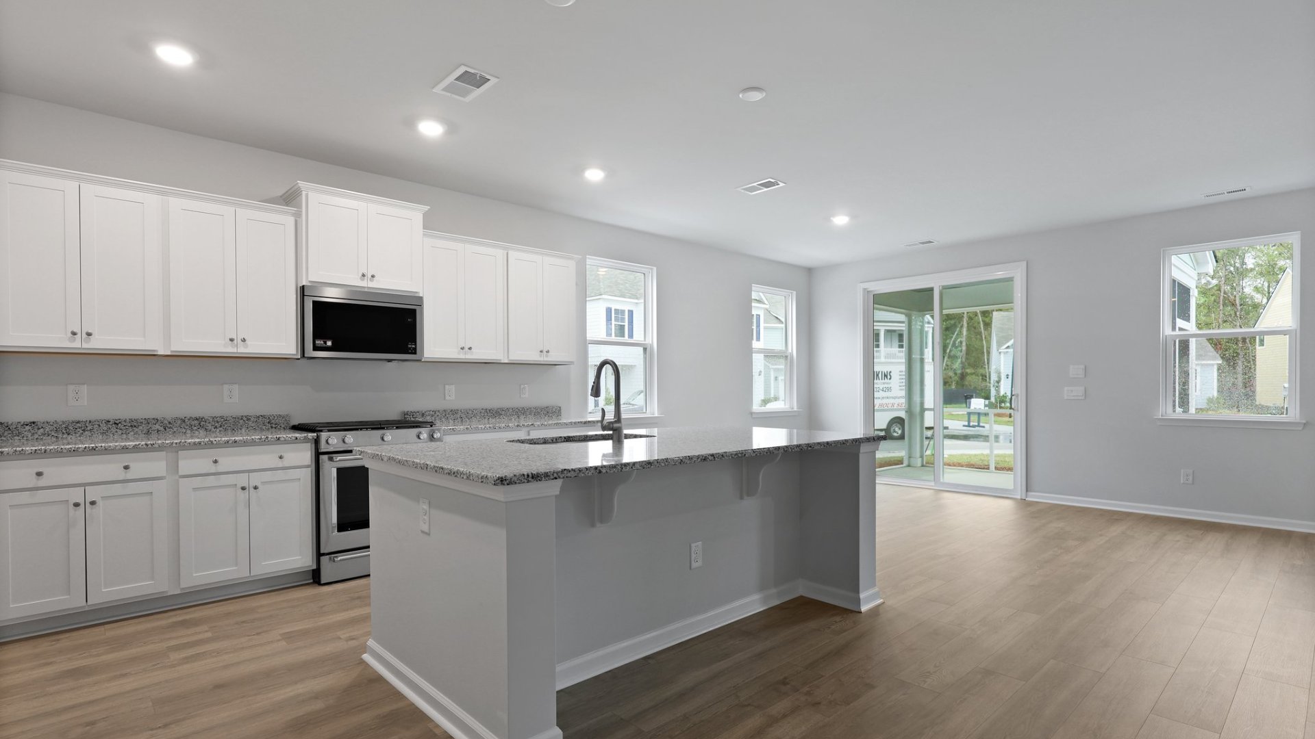 The kitchen is well lit from the sliding glass door in the dining room as well as windows in the living room.