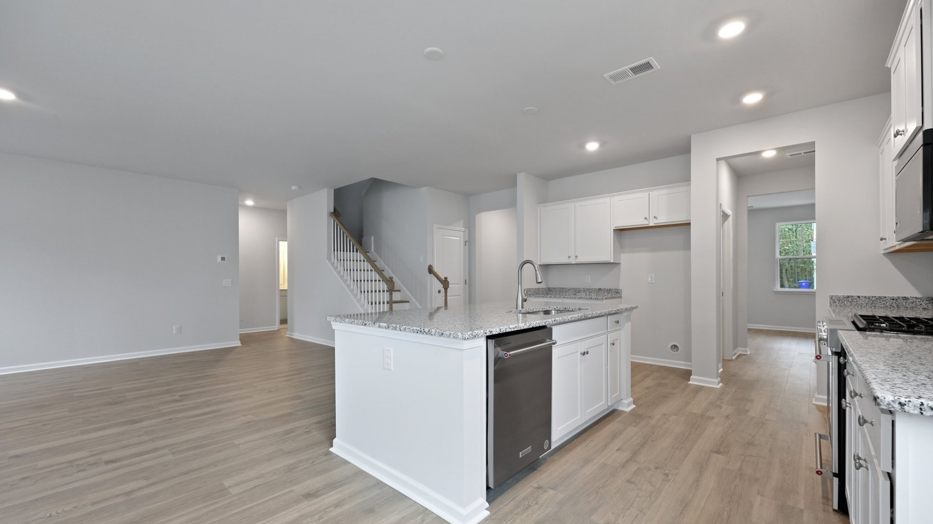 There is a granite island in the kitchen offering extra counterspace.